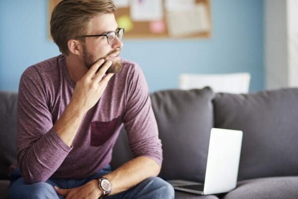 Man sitting on sofa and thinking