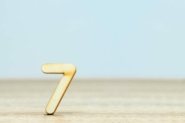 Gold number seven on blue background