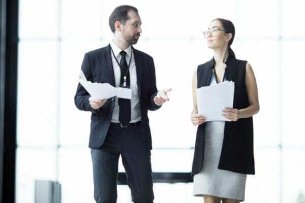 Businessman delegating to businesswoman