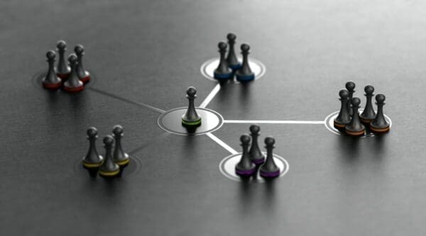 Chess pieces in a network web with leader figure in the centre