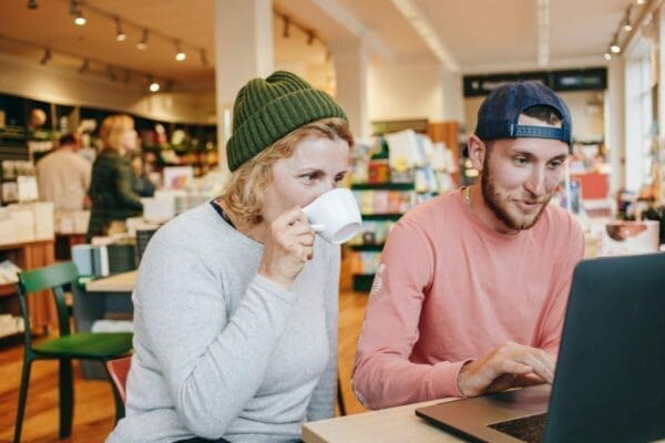 Man and woman working on a project on a laptop