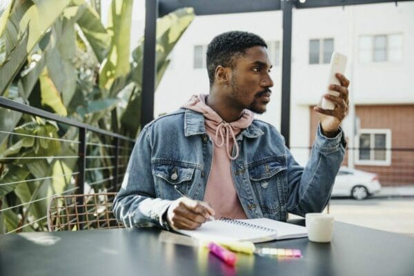 Man getting checking phone notification is distracted from his work