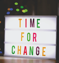 Time For Change in colourful letters on lit up sign