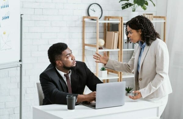 A boss shouting at an employee about Buyer Tactics in Negotiation