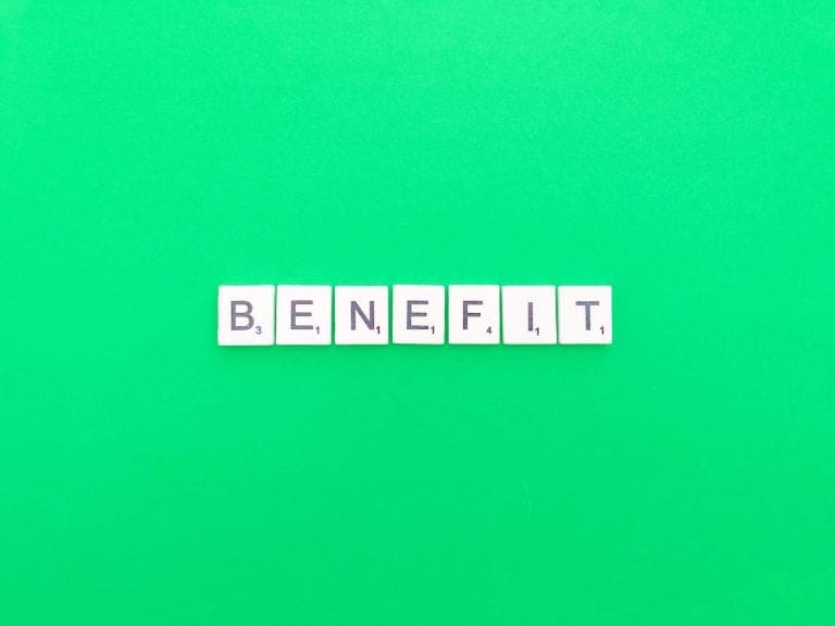 The word benefit spelt out in scrabble tiles