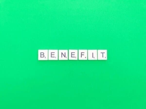 The word benefit spelt out in scrabble tiles