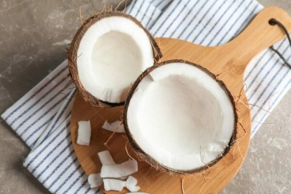 Split coconut halves on a board