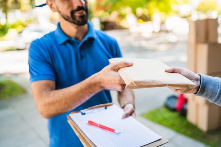 Delivery man making home delivery to customer