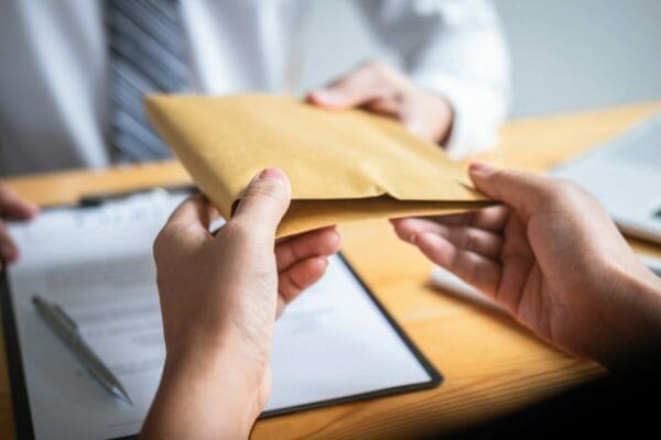 HR manager handing over a parcel to an employee