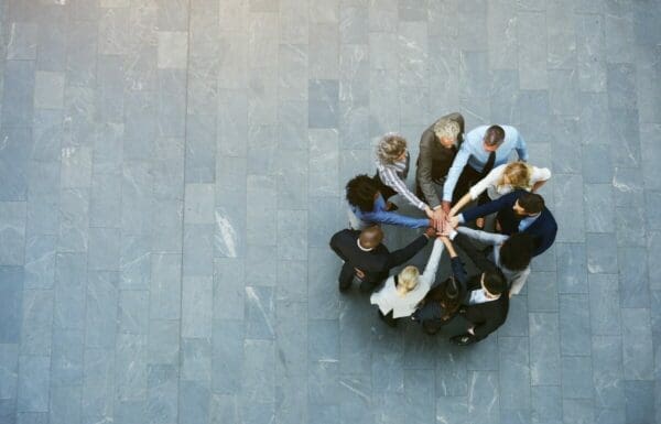 Business team members with hands in centre