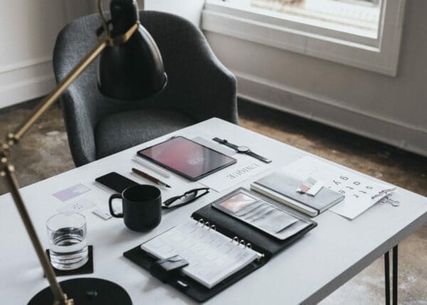 Highly organised desk area with chair and lamp