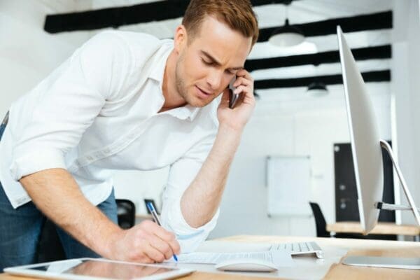 Businessman negotiating through a phone with a client