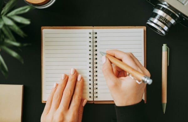 Businesswoman's hand writing in a notebook