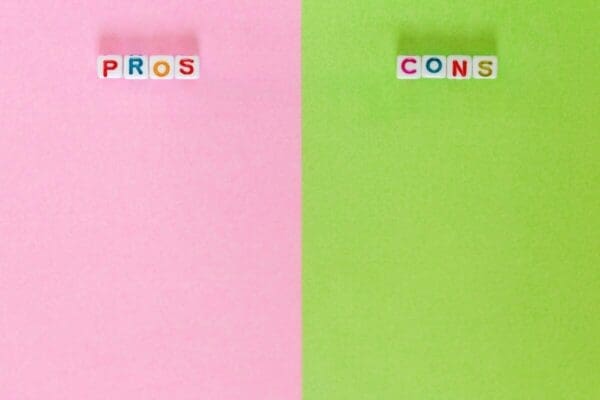 Two columns titled pros and cons with pink and green backgrounds