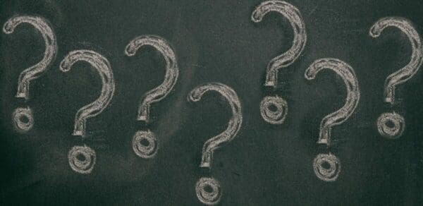 Question marks chalk drawing on blackboard