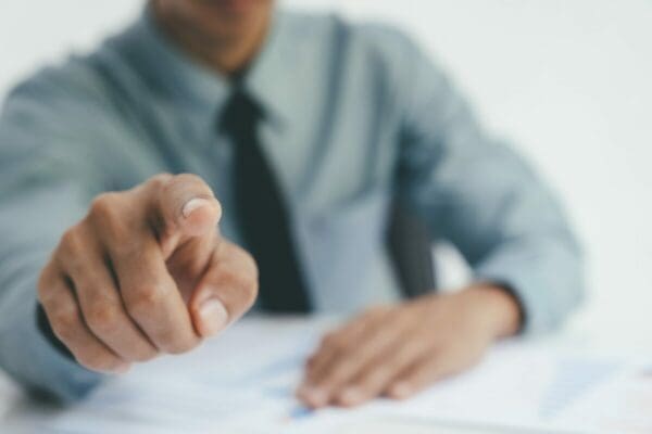 Businessman pointing at camera to signal you