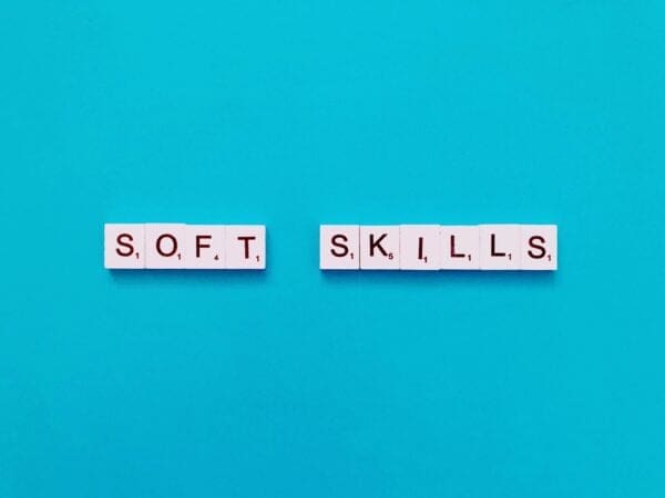 Soft skills written in scrabble tiles on blue background