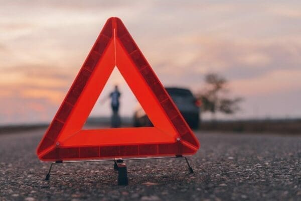 Red warning triangle sign on the road