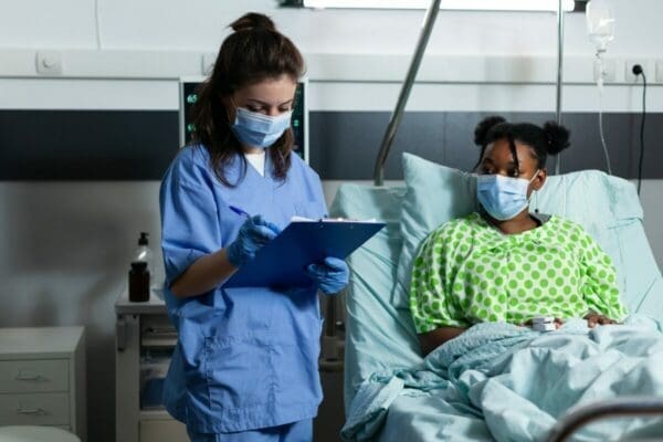 Caucasian nurse checking on sick african american patient