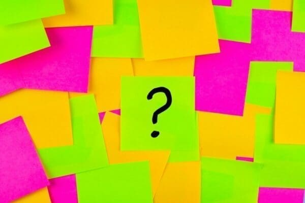 Question mark drawing on a post it note surrounded by other colourful post it notes