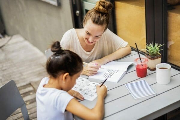 Young teacher tutoring a child one-to-one to build rapport