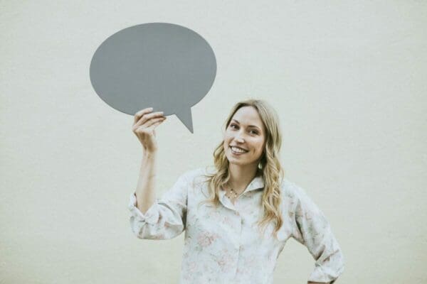 Businesswoman holding speech bubble