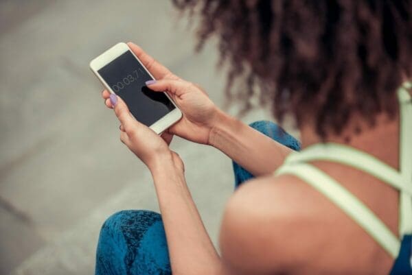 Woman holding a iPhone and setting a timer