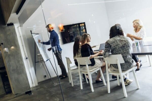 Businessman doing an office presentation before female colleagues at work 