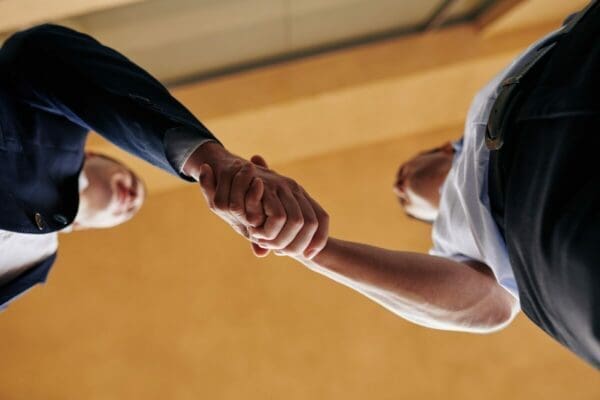 Up view of two businessmen doing a successful negotiation handshake