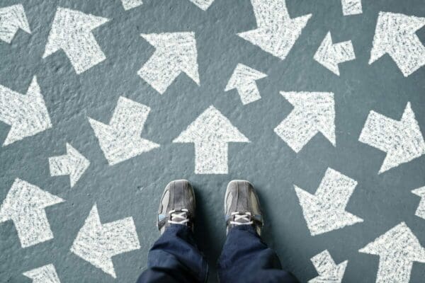 Feet surrounded by white arrows on the floor