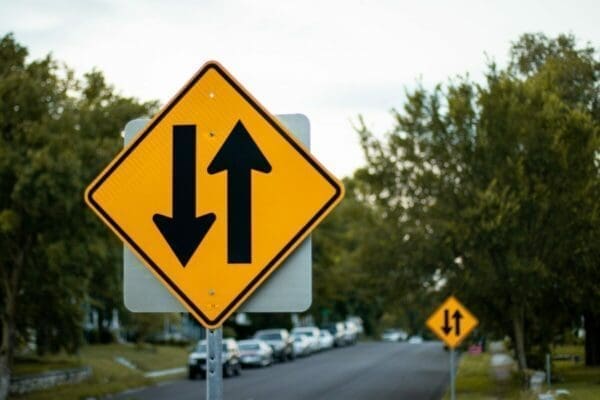 Yellow and black two way street sign