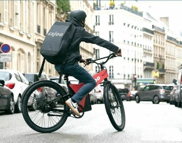 Cajoo delivery man on a bike with black knapsack