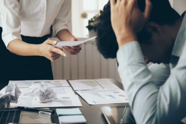 Businesswoman blaming partner during a conflict