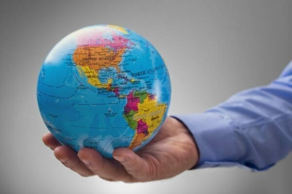 Businessman holding the world in his hands showing countries for mental health