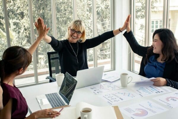 Team of Businesswomen high fiving represents great work relationships