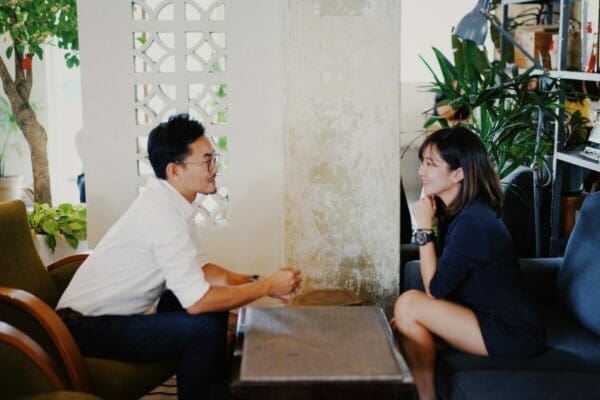 Businessman and woman starting a conversation in an office