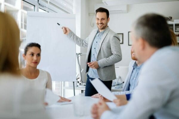 Male trainer presenting during a management training meeting