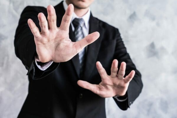 Businessman showing his palms represent no