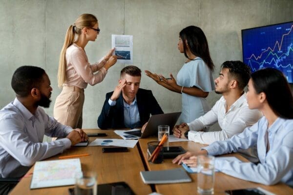 Conflict in a noisy office between two female employees and stressed boss