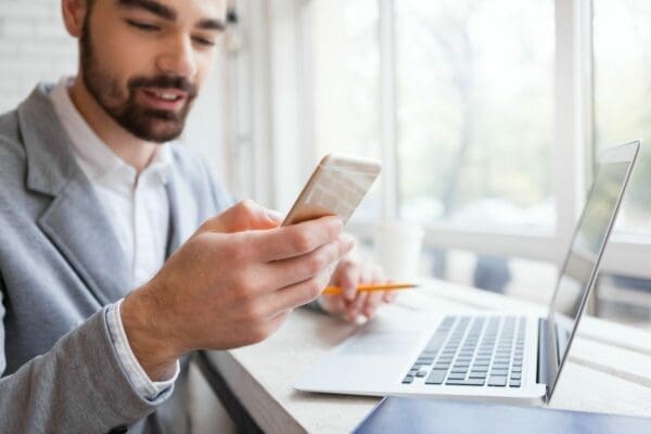 Businessman negotiating through text on his phone