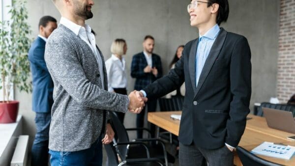 Young businessman shaking hands with his mentor