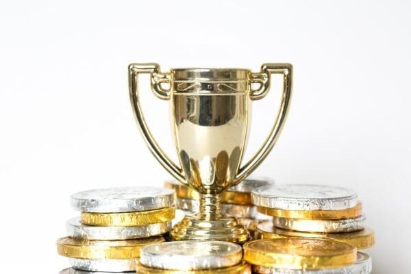 Gold trophy surrounded by prize money for employee recognition award
