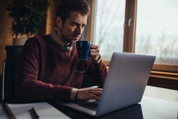 Transactional leader using a laptop as he works alone