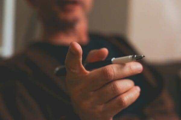Man pointing finger with pen in hand and background blurred