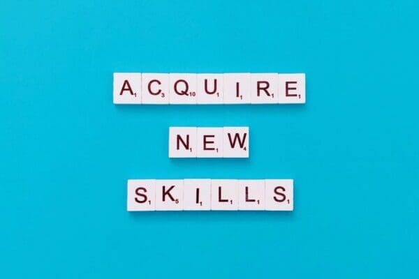 Acquire new skills quote on blue background
