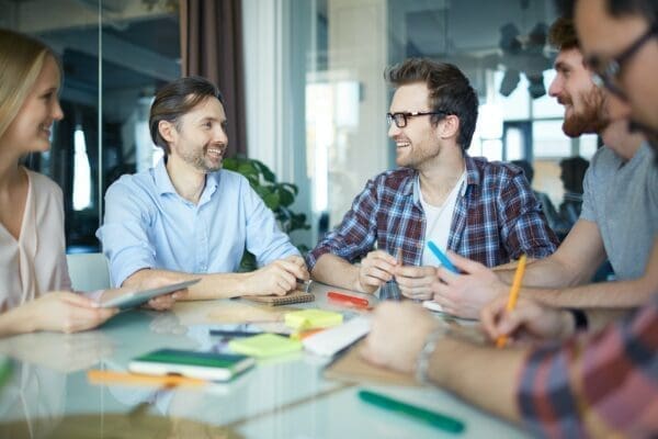 Group of colleagues around a table displaying Interpersonal Skills and Communication Skills