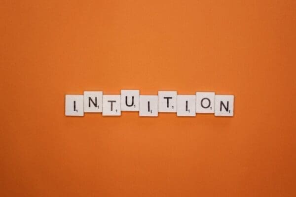 Intuition spelled with word scramble cubes on orange background