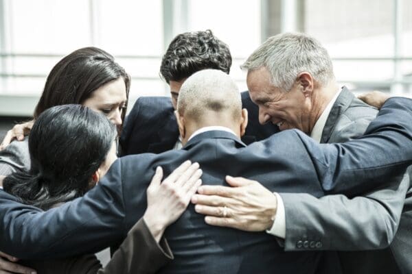 Group of business people huddling