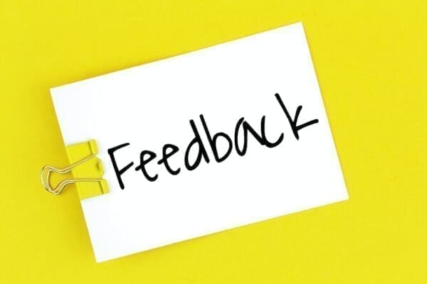 Feedback Feedback written on clipped note with yellow background