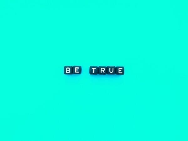 Be true quote Be true spelled with black cubes on a blue background